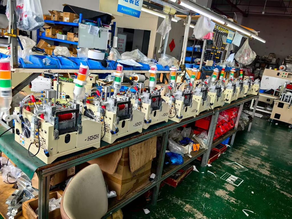 Manufacturing technician monitoring automated film processing system to reduce production scrap